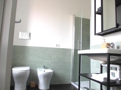 a bathroom with a toilet and a sink at Lexie Suites in Rome