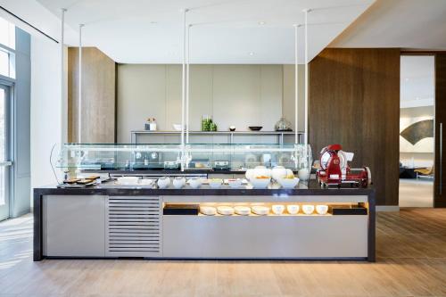 a kitchen with a counter with food on it at AC Hotel by Marriott Irvine in Irvine