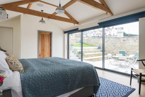 a bedroom with a bed and a view of a patio at The Printworks in Salcombe