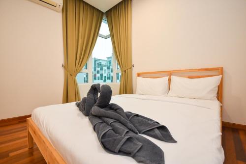 a bedroom with a bed with towels on it at 1Medini Theme Suite by Nest Home【LEGOLAND】 in Nusajaya