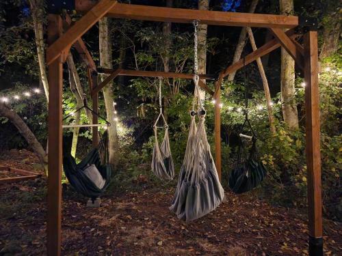 a group of hammocks hanging from a wooden structure at Rustic A-Frame hot tub retreat near Deception Pass in Oak Harbor