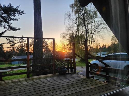 a wooden deck with a car parked on it at Rustic A-Frame hot tub retreat near Deception Pass in Oak Harbor