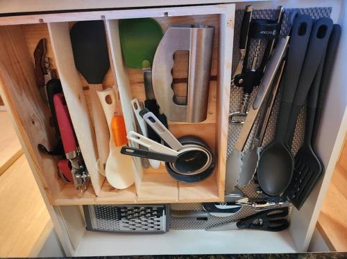 a cabinet filled with lots of kitchen utensils at Rustic A-Frame hot tub retreat near Deception Pass in Oak Harbor