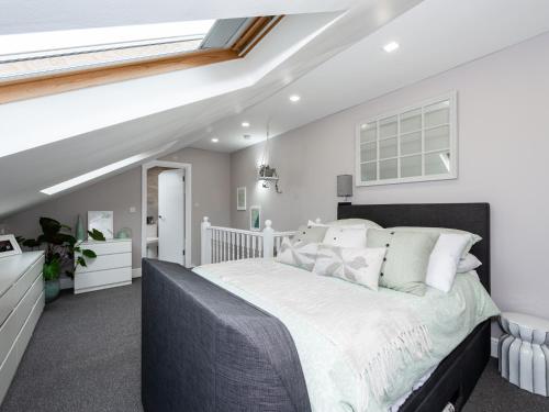 a bedroom with a large bed in a attic at Amazing Lovely 1BDR Apartment, South London in Forest Hill