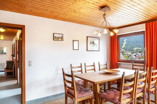 a dining room with a wooden table and chairs at Haus Excelsior Top 26/27 in Seefeld in Tirol
