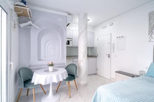 a bedroom with a table and two chairs and a bed at Silver horizon Luxury apartment in Nerja