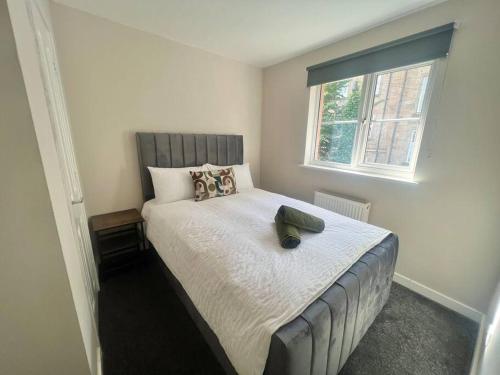 a bedroom with a large bed with a window at Modern 3 Bedroom Home In Glasgow in Glasgow