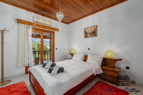 a bedroom with a large bed and a window at Alonia Cottage in Episkopí