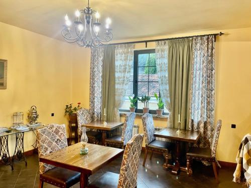 a dining room with tables and chairs and a window at Hotel Villa Alexander Dilijan in Dilijan