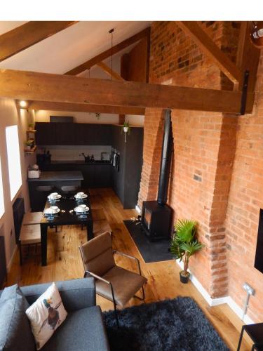 an overhead view of a living room with a brick wall at DJH Homes - Luxurious and chic 3BR Grade II Industrial House with log burner and electric blinds - JQ, Birmingham City in Birmingham