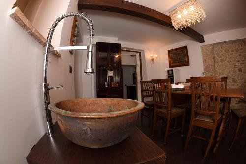 an old tub sitting on a table in a room at San Francesco Suite in Poggio Bustone