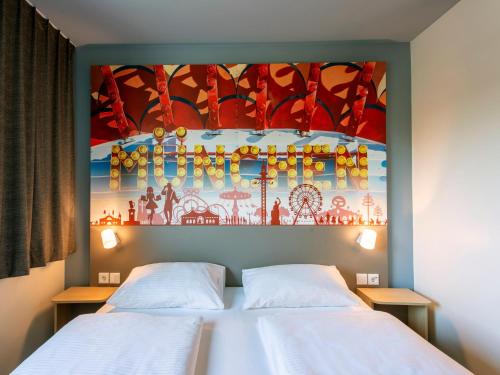 two beds in a room with a painting on the wall at B&B Hotel München City-West in Munich