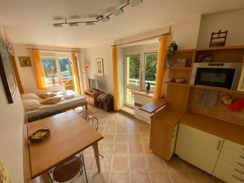 a kitchen with a table and a counter top at Apartmány Tatran Donovaly in Donovaly
