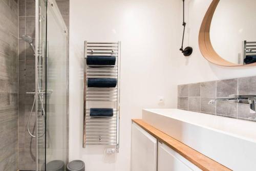 a white bathroom with a sink and a shower at Cabana & Appartement type Loft - Bellecour in Lyon