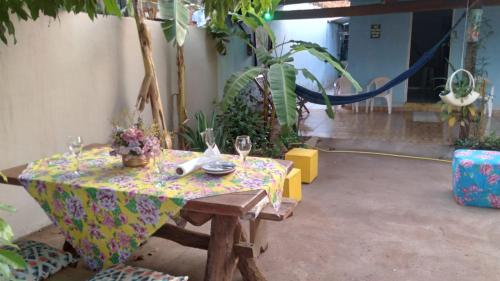 a table with a table cloth with wine glasses on it at Casa Pedacinho do Céu in Nobres