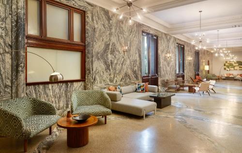 a living room with a couch and chairs at Le Meridien Tampa, The Courthouse in Tampa