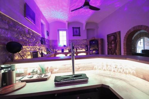 a purple room with a altar with a candle on a table at Naturtalente Villa in Sankt Johann in der Haide