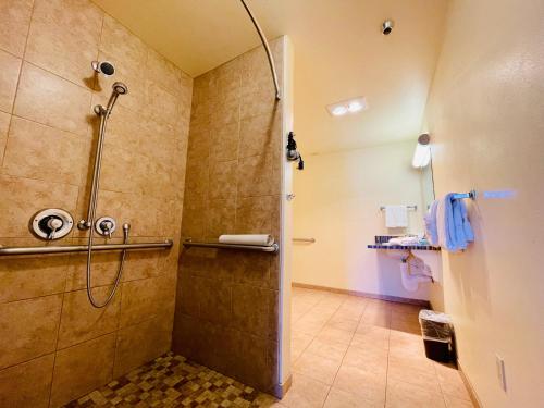 uma casa de banho com um chuveiro e uma porta de vidro em Seabird Lodge Fort Bragg em Fort Bragg