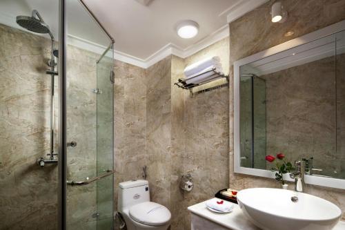 a bathroom with a toilet and a sink and a shower at Hanoi Golden Moon Hotel in Hanoi