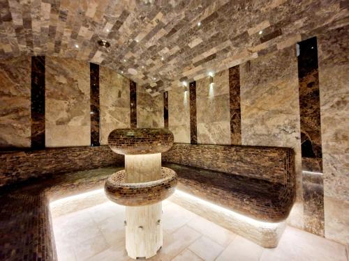 a bathroom with a toilet in the middle of a room at Hotel Kocourkov in Hlinsko