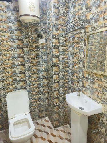 a bathroom with a toilet and a sink at HOTEL ASHOKA PALACE Near IGI Airport New Delhi in New Delhi