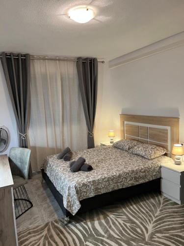 a bedroom with a bed and a chair in it at Sinforosa Park Apartments in Torrevieja