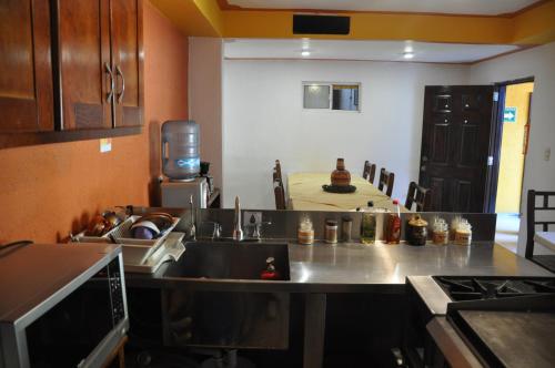 a kitchen with a sink and a counter top at Hotel Ecológico Temazcal in Creel