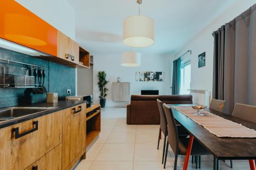 a kitchen and dining room with a table and a couch at The Attico in Padenghe sul Garda