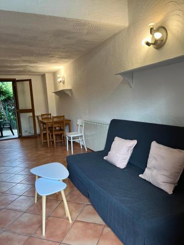 a living room with a blue couch and a table at Casa Vacanze La Riserva Maccarese in Maccarese