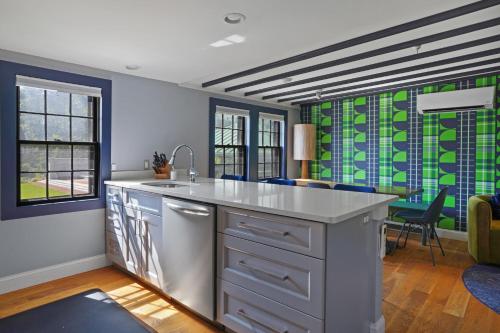 a kitchen with blue and green windows and a counter at Cape Cod Mod in Provincetown