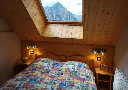 une chambre avec un lit avec une grande fenêtre dans l'établissement Duplex Les 2 Alpes avec accès direct aux pistes, à Les Deux Alpes