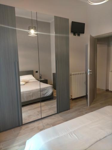 a reflection of a bedroom with a bed and a mirror at Cherry's house in Celleno
