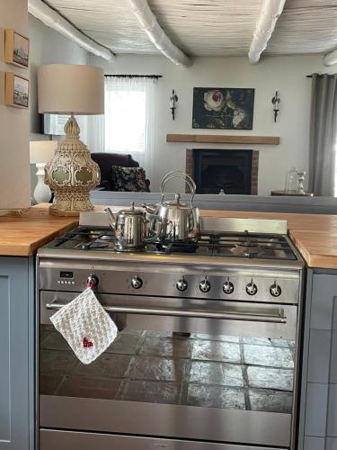 a kitchen with a stove with two pots on it at 13 On Vigne in Greyton