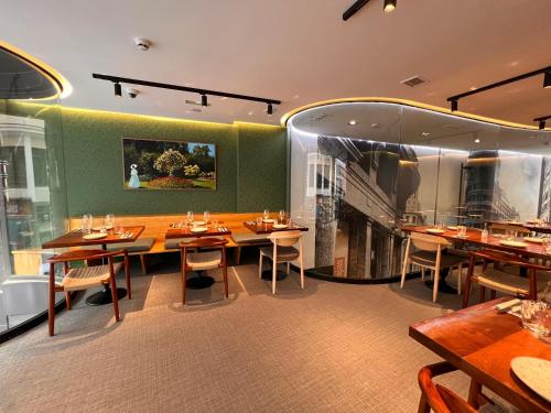 a restaurant with wooden tables and chairs in a room at Hotel Indigo Madrid - Gran Vía by IHG in Madrid