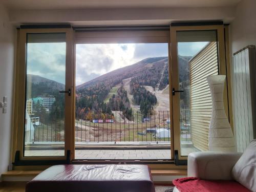 a large window with a view of a mountain at Apartman VM in Bjelašnica