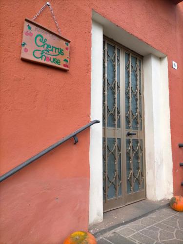 a sign on the side of a building with a door at Cherry's house in Celleno