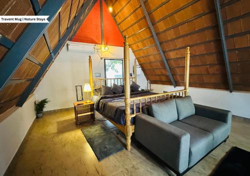 a bedroom with a bed and a couch in a room at Oh - Bali Villa by Travent Mug in Rāmanagaram