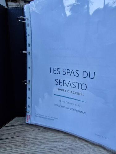 un livre avec les mots las spas du seascoria dans l'établissement Les Spas du Sébasto, à Lille