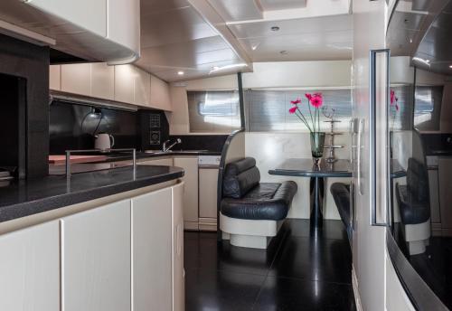 a kitchen with a table and a dining room at Super Yacht Located in Puerto Banus in Marbella