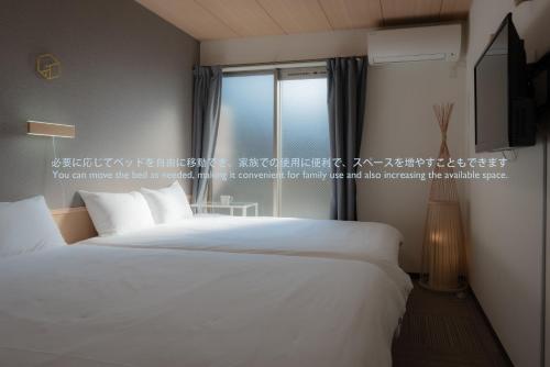 INA HOUSE Nijojoにあるベッド