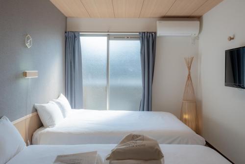 INA HOUSE Nijojoにあるベッド