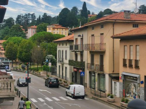 a view of a city street with cars and buildings at Room in shared apartment, near Lecco in Calolziocorte