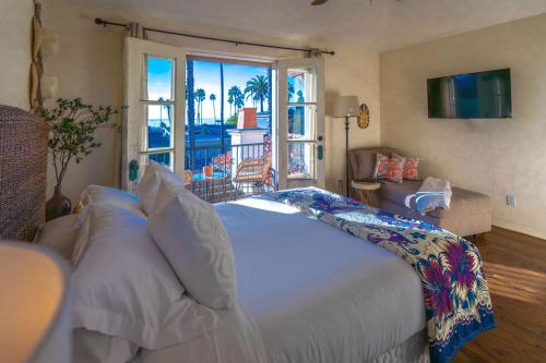 a bedroom with a large bed with a view of the ocean at Ocean View Spanish Beauty Half Block to Beach in San Diego