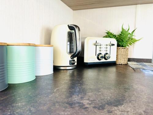 a toaster and coffee pots sitting on a kitchen counter at Adelfas in Scarborough