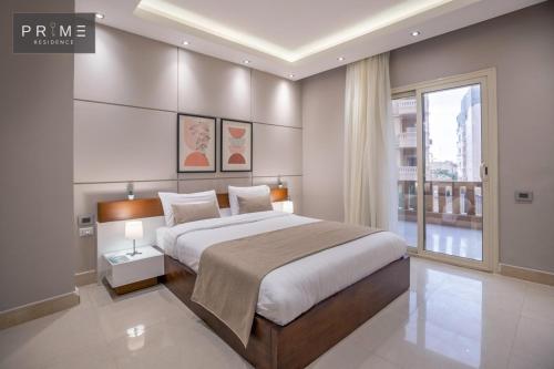 a bedroom with a large bed and a large window at Prime Residence New Cairo in Cairo