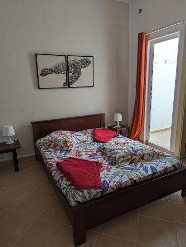 a bedroom with a bed and a window at African Sunset in Sal Rei
