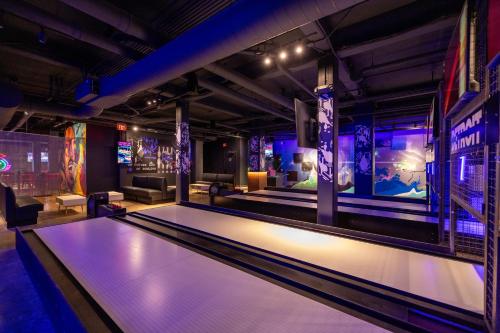 a room with a pool table and bowling lanes at Cambria Hotel Detroit Downtown in Detroit