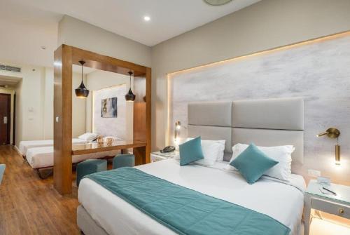 a hotel room with a large bed with blue pillows at Tolip Family Park Hotel in Cairo