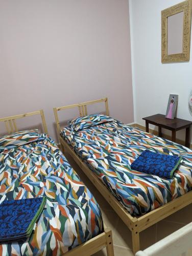 two beds sitting next to each other in a room at African Sunset in Sal Rei