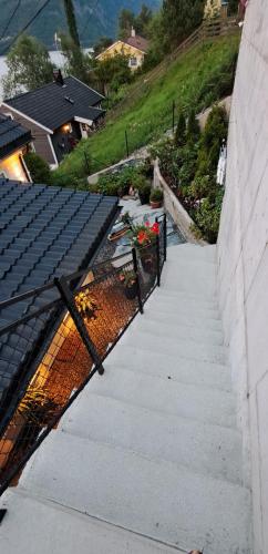 a staircase leading up to a house with flowers on it at Bergen sunrise Apartment - self check in - Free Parking in Bergen